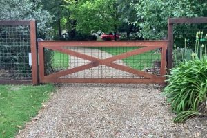 Timber swing gates with a simple frame design with cross-bracing cladding